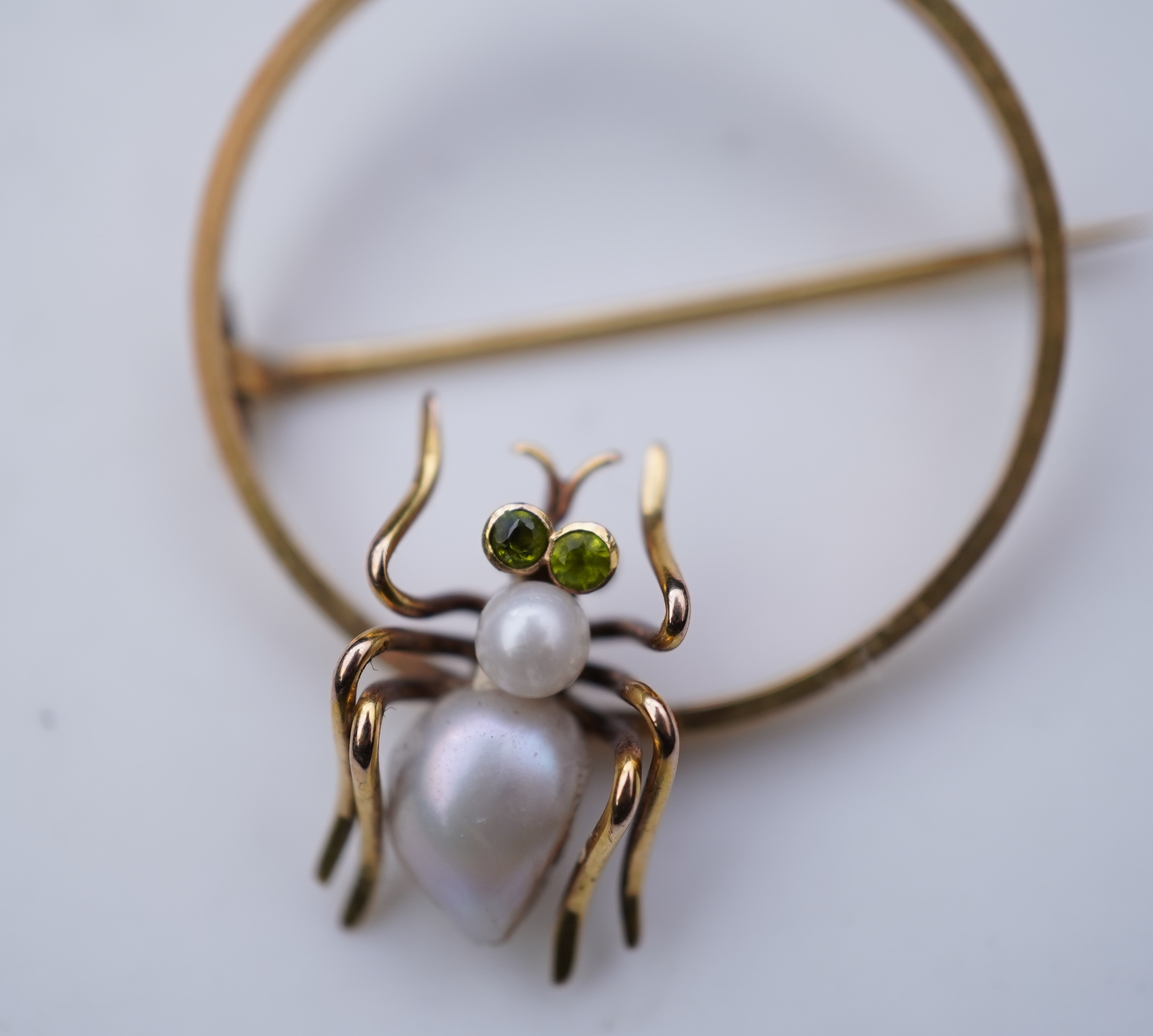 A n Edwardian gold pearl and peridot novelty brooch, early 20th century